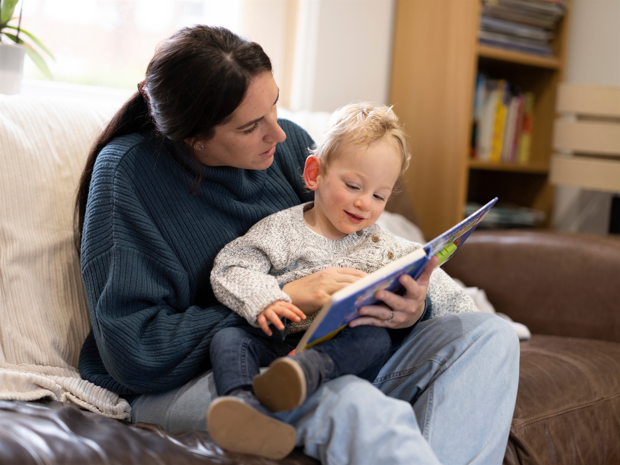 Mom reading book to child